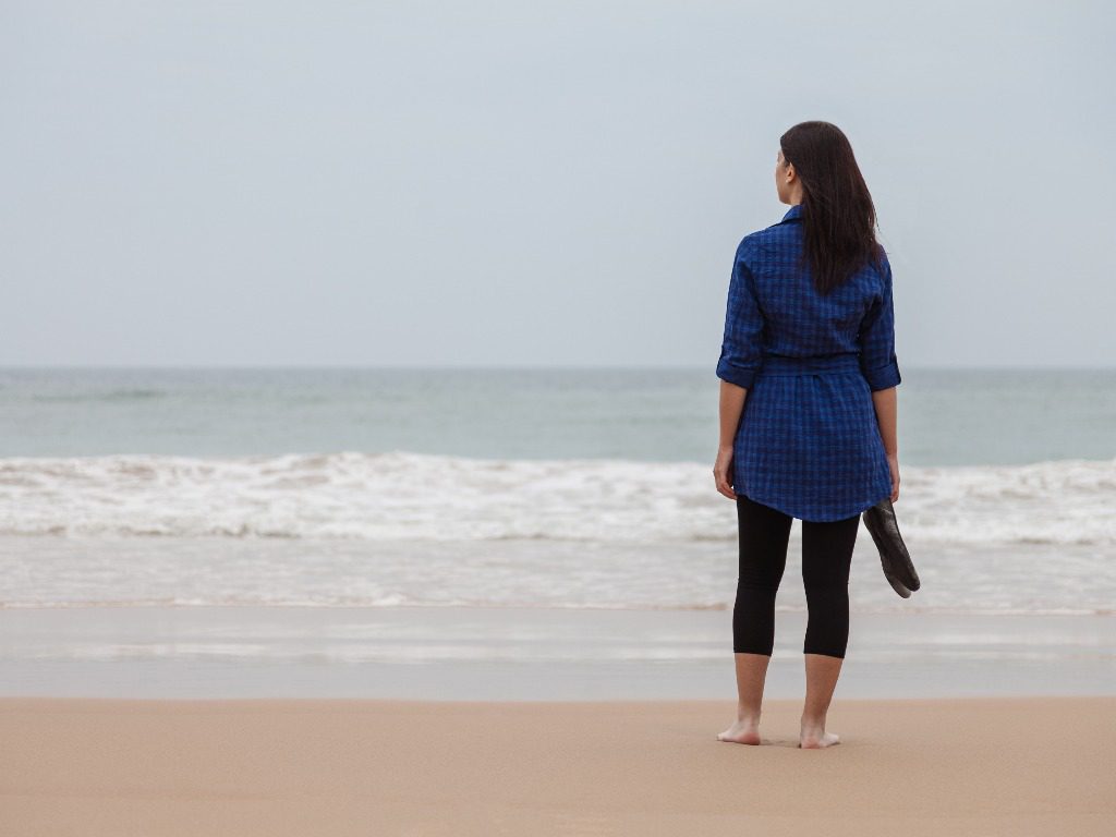 woman standing on the shoreline